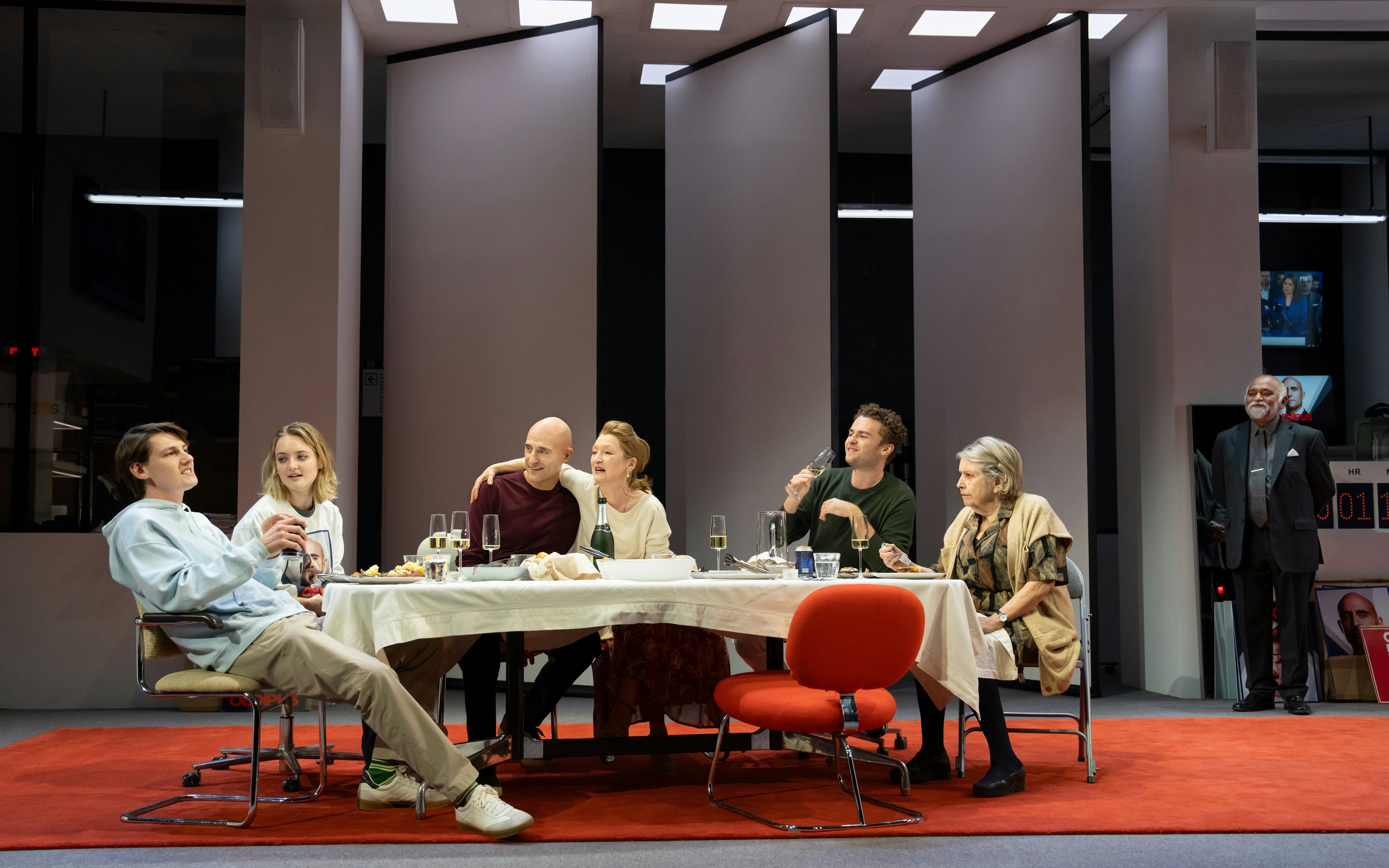 Actors performing a dinner scene at the Oedipus Broadway show.