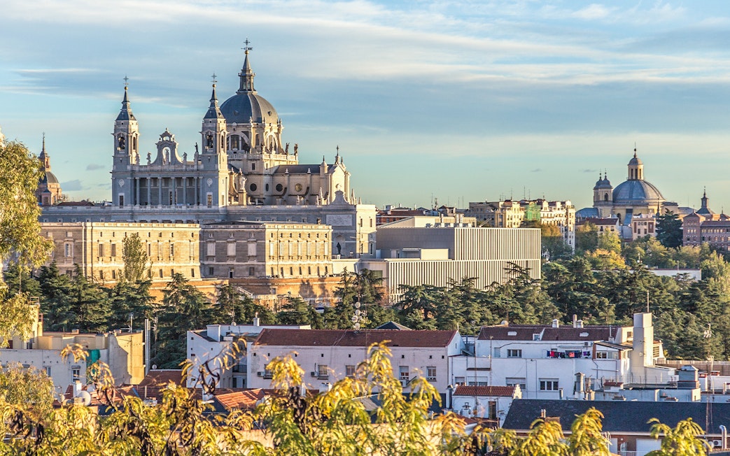 Royal Palace of Madrid and Almudena Cathedral viewed from a distance.