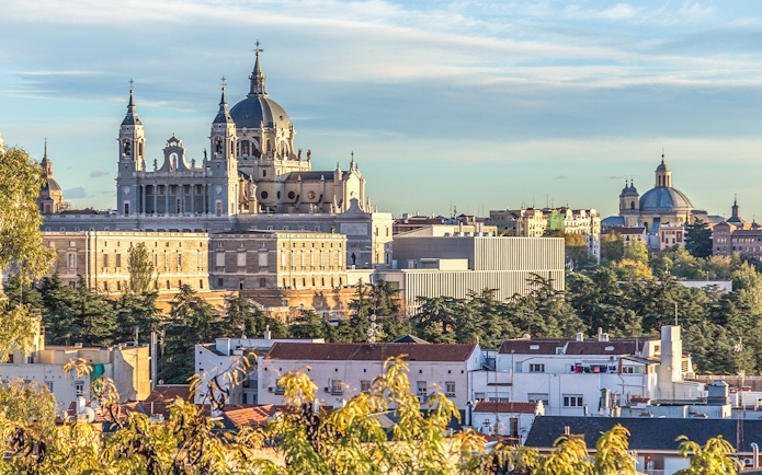 Royal Palace of Madrid and Almudena Cathedral viewed from a distance.