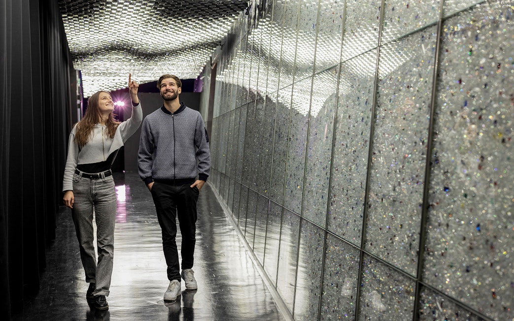 Visitors exploring a sparkling corridor at Swarovski Crystal Worlds.