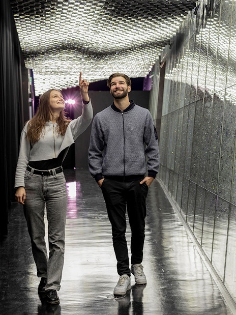 Visitors exploring a sparkling corridor at Swarovski Crystal Worlds.