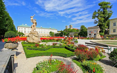 Mirabell Gardens with statues and colorful flowers in Salzburg, Austria.