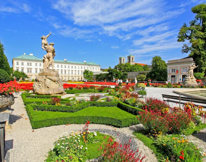 Mirabell Gardens with statues and colorful flowers in Salzburg, Austria.
