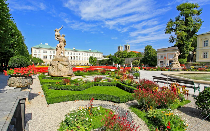 Mirabell Gardens with statues and colorful flowers in Salzburg, Austria.