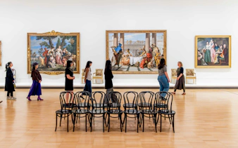 Visitors viewing classic paintings at the National Gallery of Victoria.