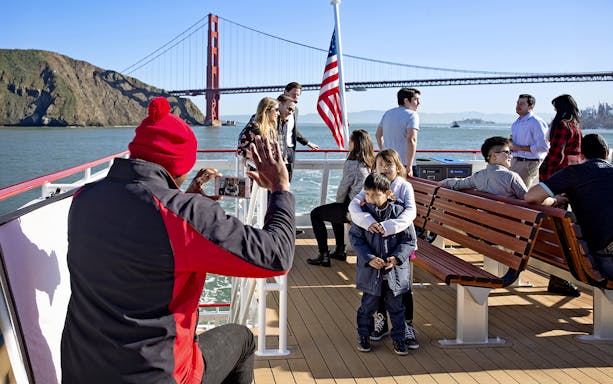 Bay Cruise passengers photographing Golden Gate Bridge, San Francisco.