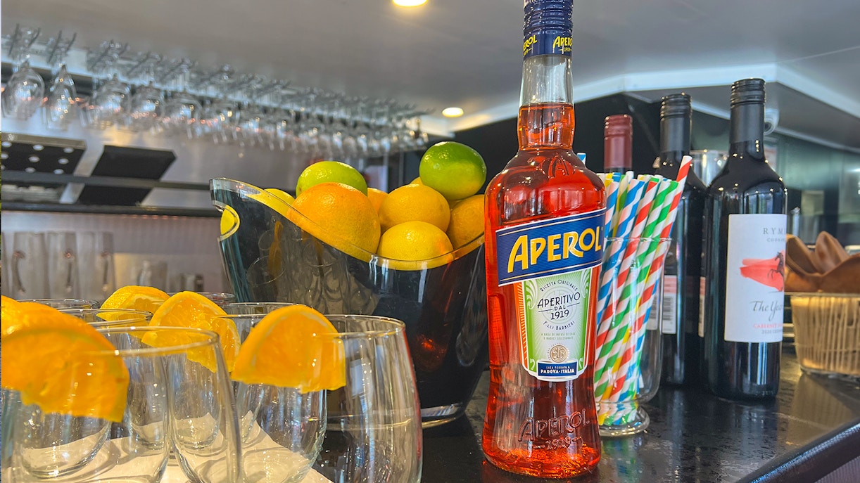 Aperol bottle and citrus fruits on bar for Bottomless Brunch Cruise in Melbourne.