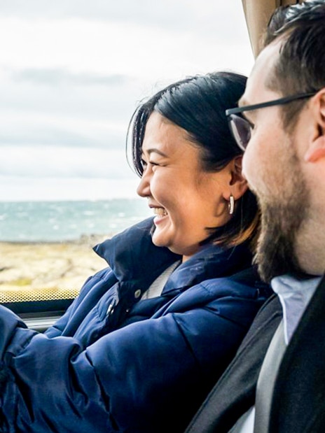 Passengers enjoying scenic views on a bus from Reykjavik Keflavik Airport to Reykjavik BSI Terminal.