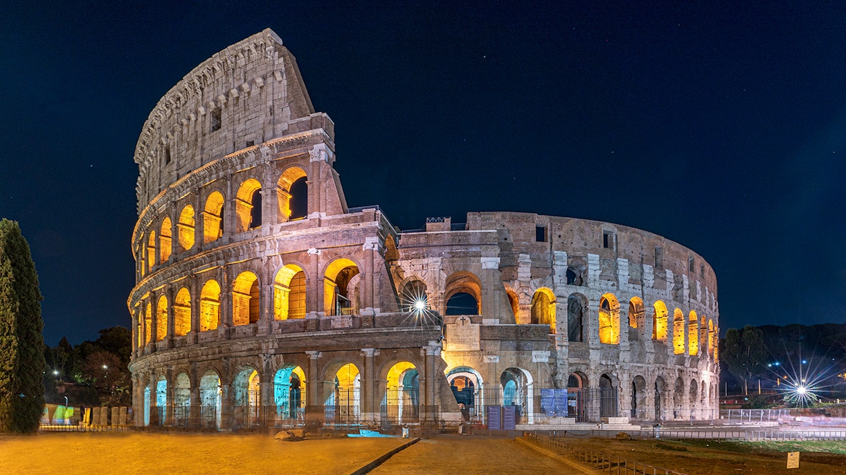 Colosseum illuminated at night in Rome, Italy.