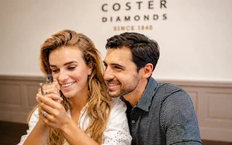 Couple examining diamond at Coster Diamonds, Amsterdam.