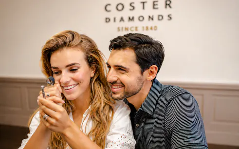Couple examining diamond at Coster Diamonds, Amsterdam.