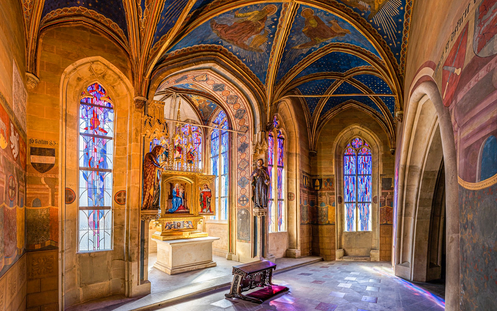 Interior of the Gothic Chapel of the Virgin Mary, Old Town Hall, Prague, with stained glass windows.