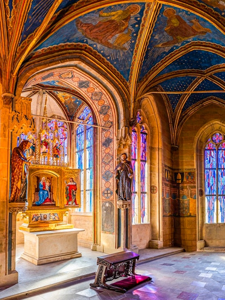 Interior of the Gothic Chapel of the Virgin Mary, Old Town Hall, Prague, with stained glass windows.