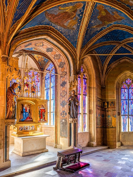 Interior of the Gothic Chapel of the Virgin Mary, Old Town Hall, Prague, with stained glass windows.