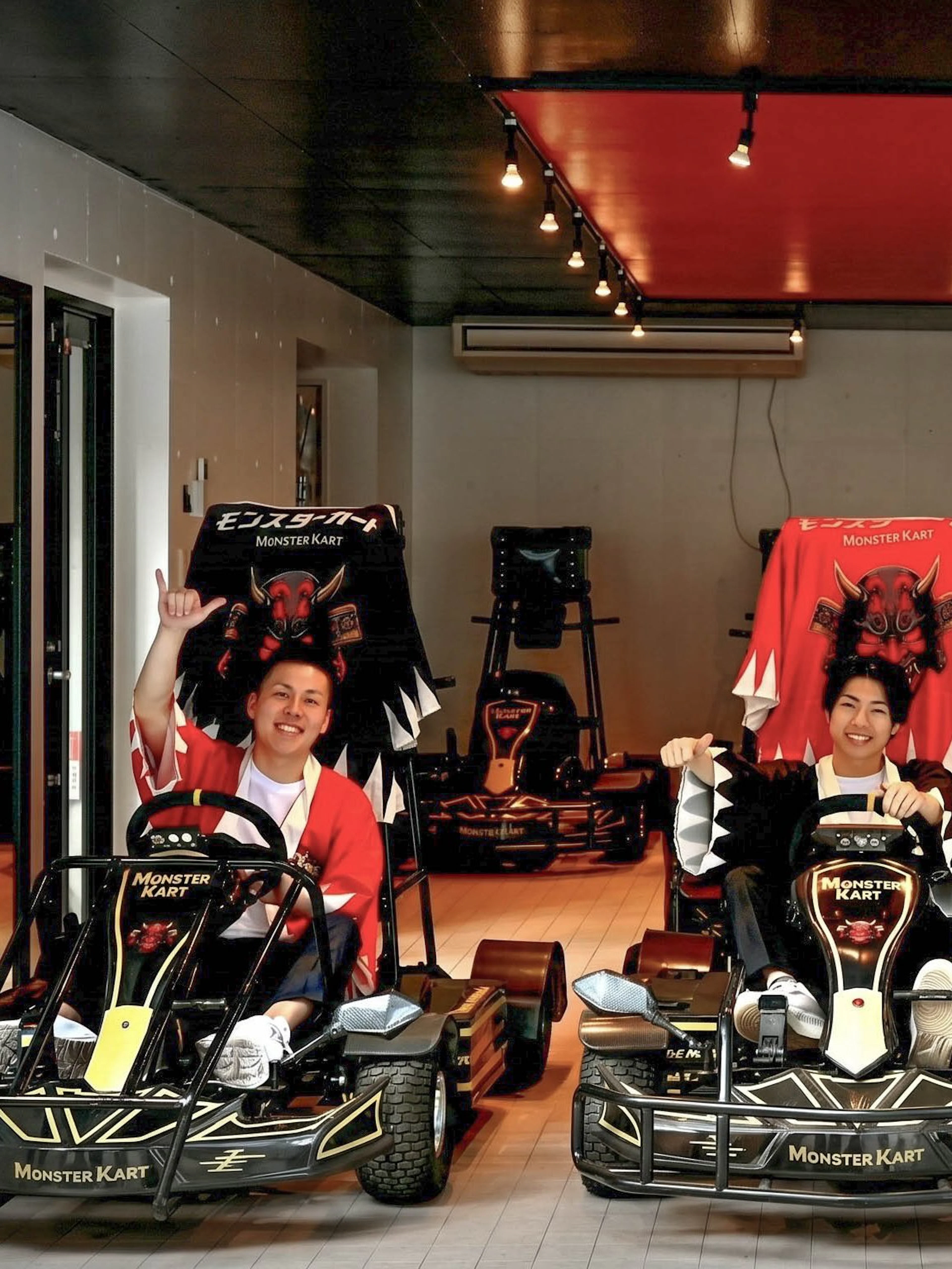 Street Kart participants in Tokyo posing in themed go-karts indoors.