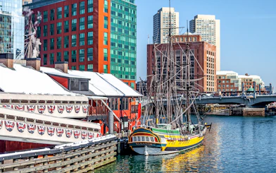Boston Tea Party Ship docked near historic buildings and waterfront.