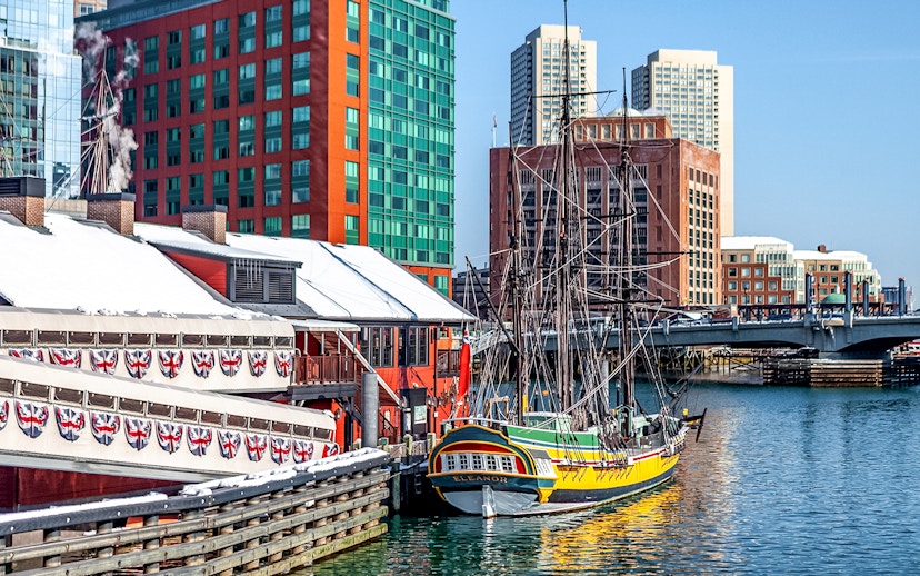 Boston Tea Party Ship docked near historic buildings and waterfront.