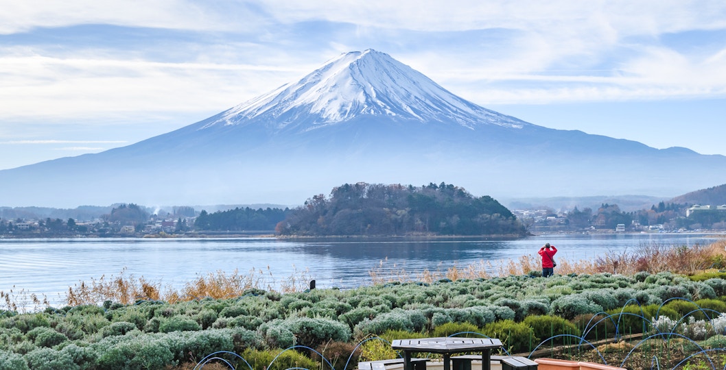 Visitor photographing Mt. Fuji from Oishi Park with Lake Kawaguchi in the foreground.