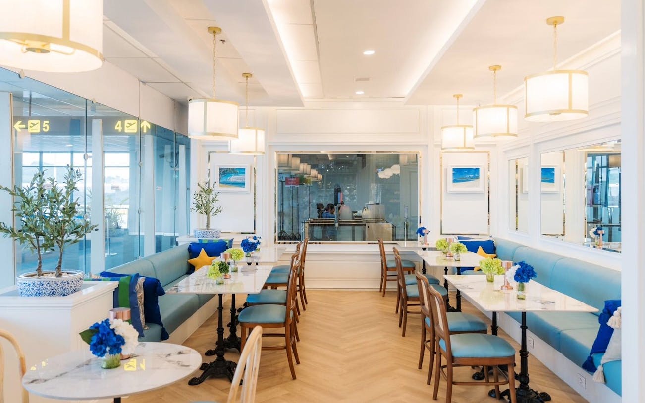 Coral International Lounge seating area with tables and decor at Phuket International Airport.