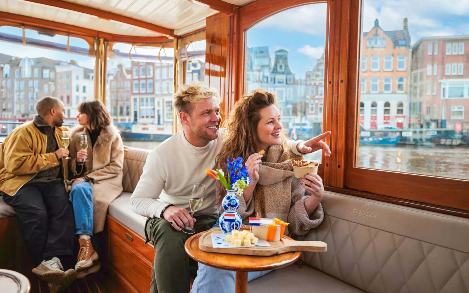 Couple enjoying a luxury romantic cruise in Amsterdam with city views.