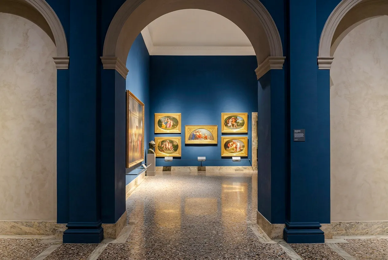 Brera Gallery interior with classic paintings on blue walls, Milan.