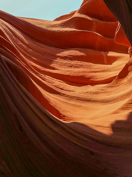 Upper Antelope Canyon's smooth, wave-like sandstone formations illuminated by sunlight.
