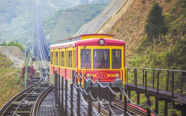 Red funicular train on tracks at Sun World Fansipan, Vietnam.