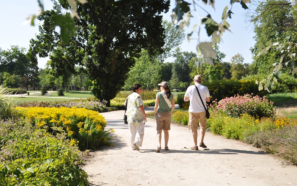 Visitors walking through gardens at Gödöllő Royal Palace near Budapest.