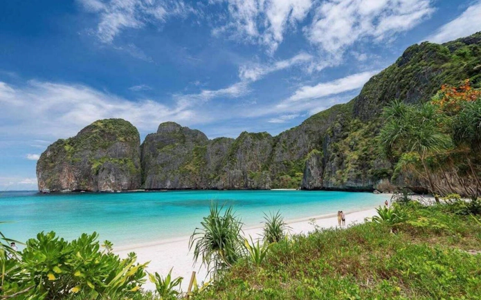 Phi Phi Islands beach with turquoise water and limestone cliffs, Thailand.