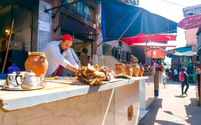 Street vendor preparing food at Jema el Fna market in Marrakesh.