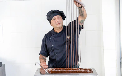 Host demonstrating chocolate making at Choco-Story Brussels Museum.