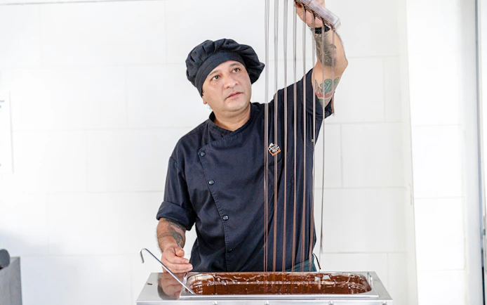 Host demonstrating chocolate making at Choco-Story Brussels Museum.