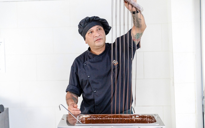 Host demonstrating chocolate making at Choco-Story Brussels Museum.