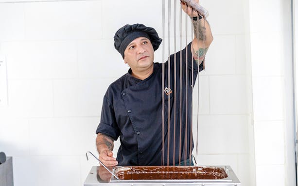 Host demonstrating chocolate making at Choco-Story Brussels Museum.