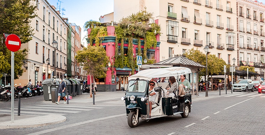 Eco Tuk Tuk touring a vibrant street in Madrid.