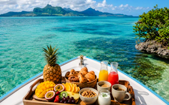 Brunch spread on a boat with tropical fruits and drinks, Mahebourg lagoon, Mauritius.