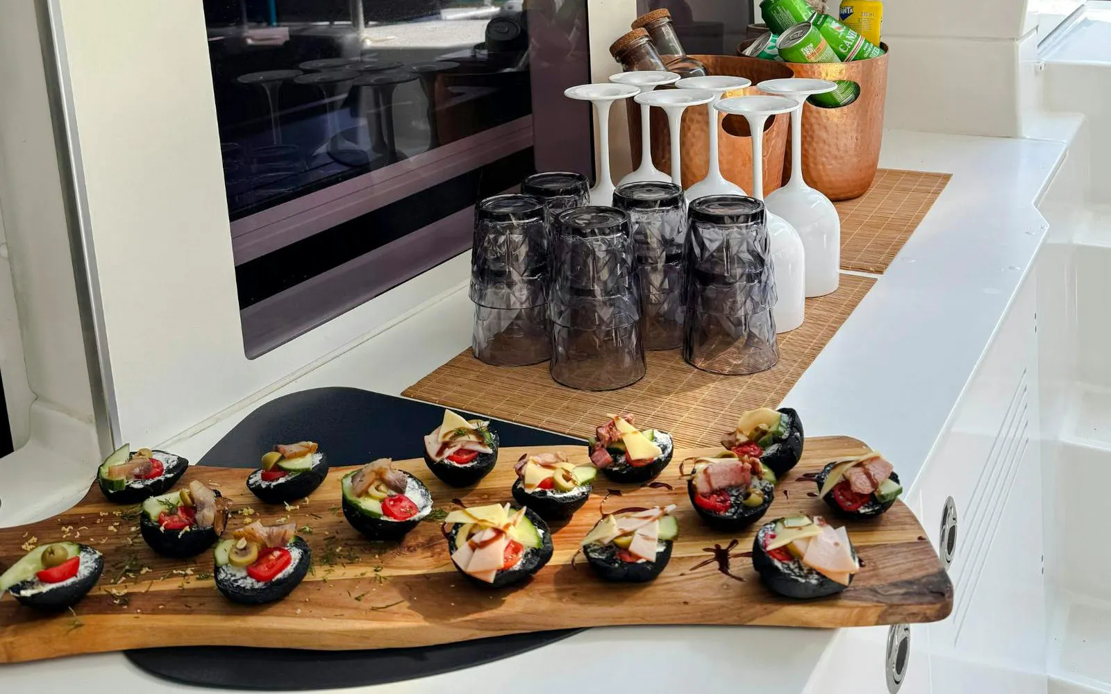 Gourmet appetizers on a catamaran in Heraklion, featuring olives, cheese, and meats.