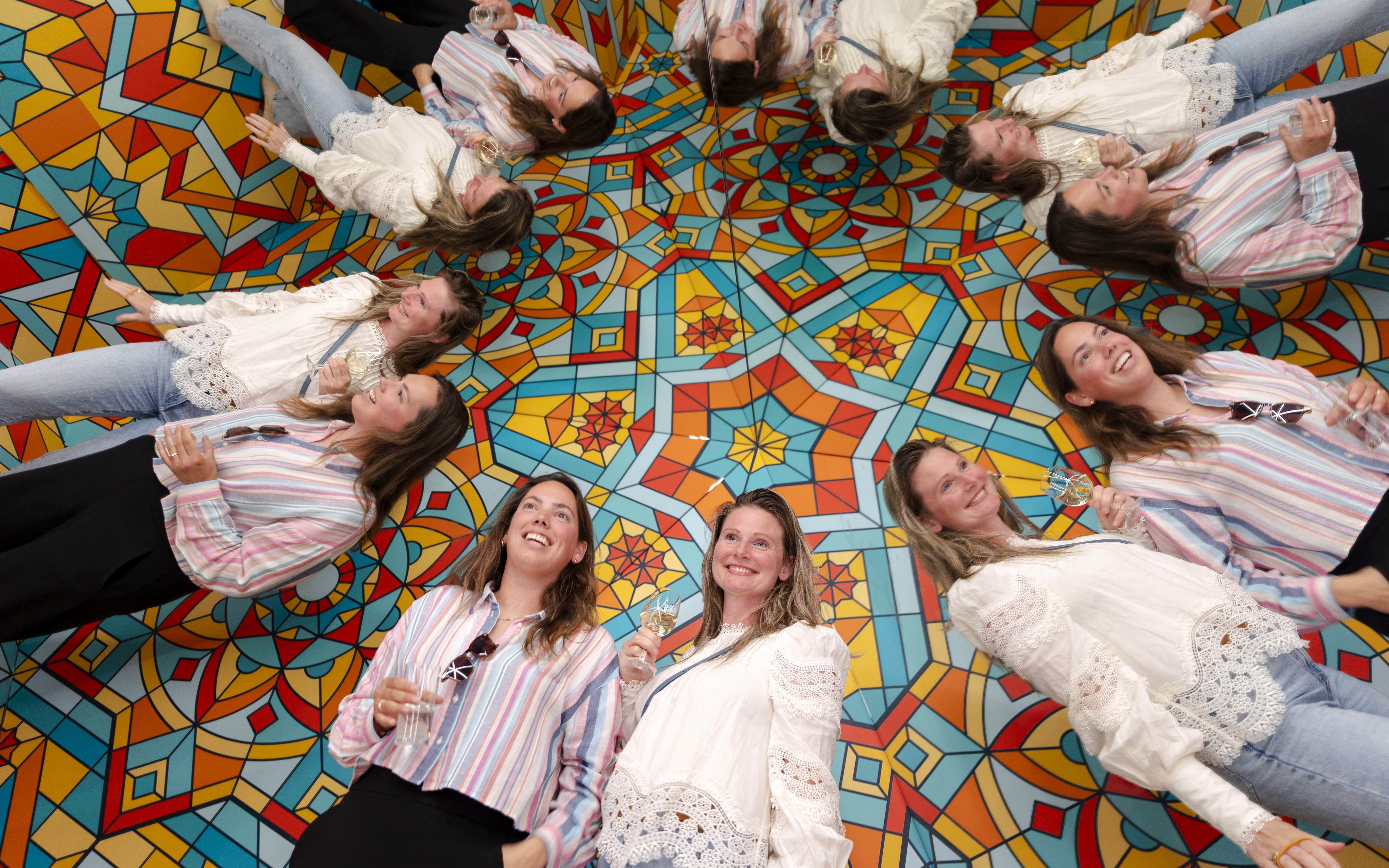 Guests enjoying mirrored illusions at the Museum of Illusions Amsterdam.