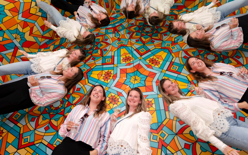 Guests enjoying mirrored illusions at the Museum of Illusions Amsterdam.