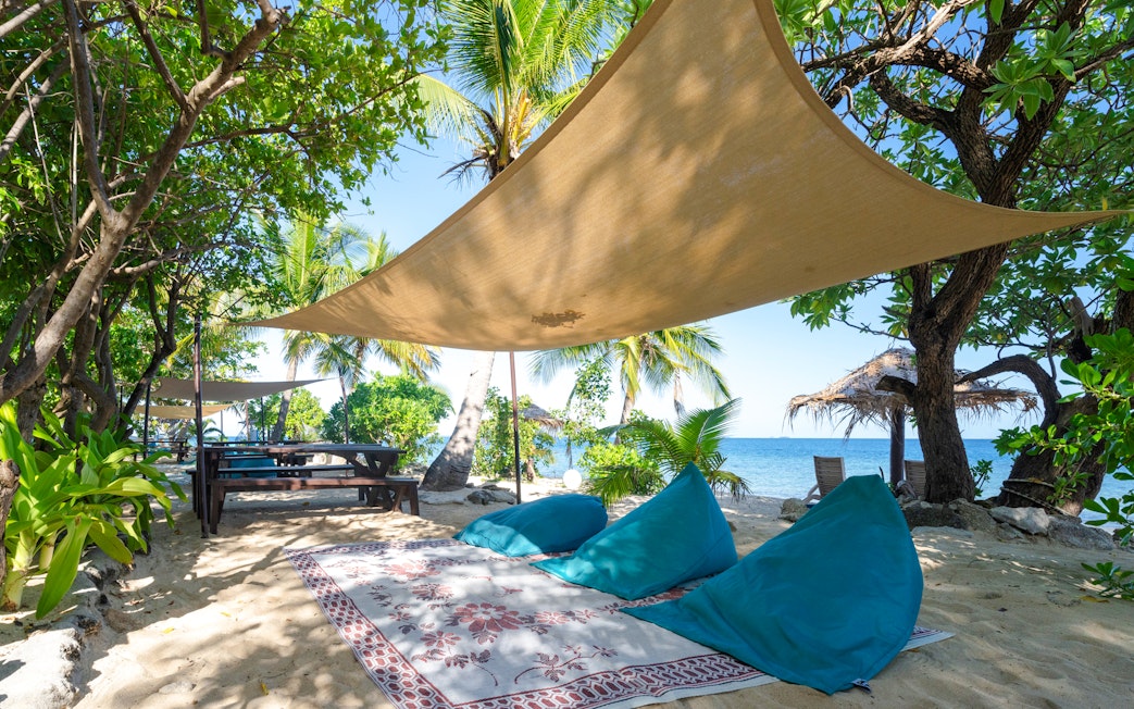 Seating arrangement with shade on South Sea Island beach, Fiji.