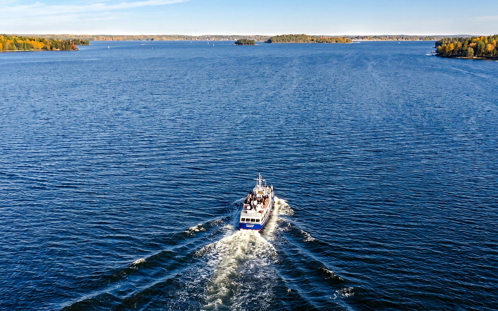 Boat cruising through Stockholm Archipelago with islands in the distance.