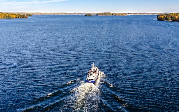 Boat cruising through Stockholm Archipelago with islands in the distance.