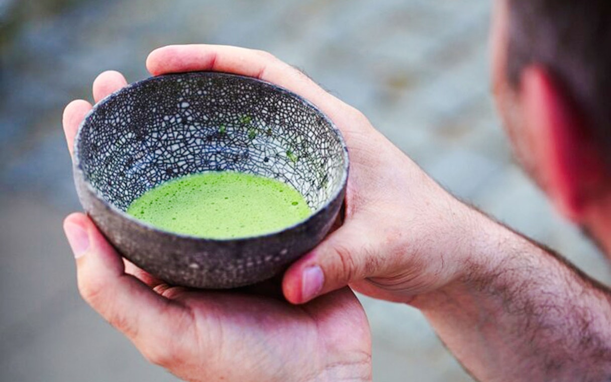 Hands holding a bowl of matcha at Tokyo Matcha & Kimono Experience.