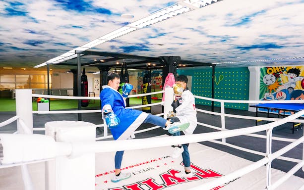 Boxing match at The Selfie Experience Phuket with colorful mural backdrop.