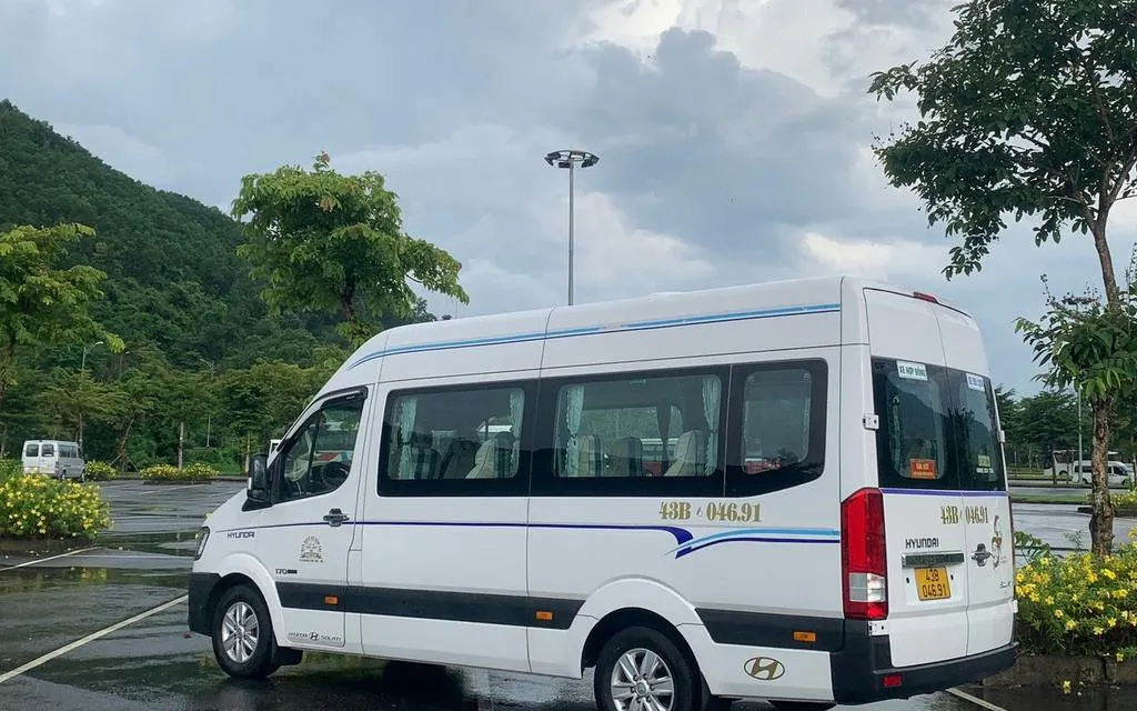 Minibus parked in a scenic area for Hue to Da Nang route.