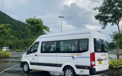 Minibus parked in a scenic area for Hue to Da Nang route.