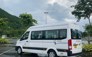 Minibus parked in a scenic area for Hue to Da Nang route.