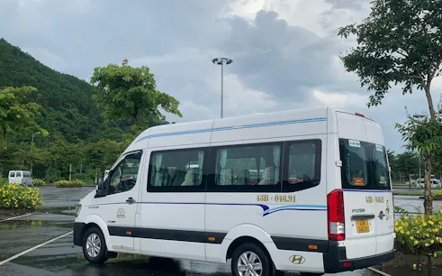 Minibus parked in a scenic area for Hue to Da Nang route.