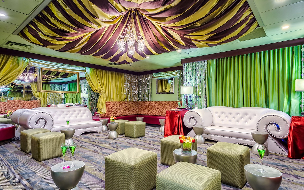 Luxurious seating area in the Green Room at Rock-A-Hula show with elegant decor and lighting.