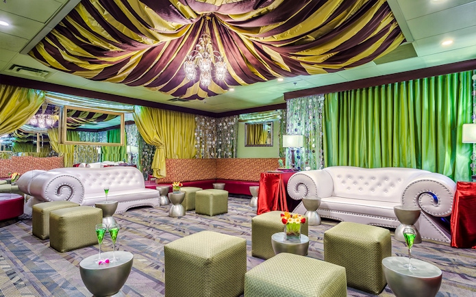 Luxurious seating area in the Green Room at Rock-A-Hula show with elegant decor and lighting.